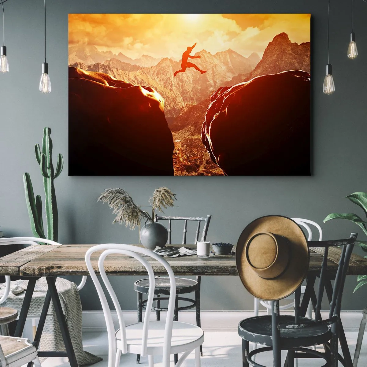 Obraz na plátne - Postava skáčuca medzi skalami s horami v pozadí - 70x50cm - Prekročením hraníc - Moderná nástenná dekorácia do obývacej izby a spálne ARTTOR