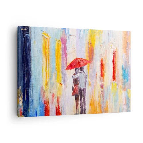Obraz na plátne - Pár pod červeným dáždnikom s farebnými budovami v pozadí. - 70x50cm - Nech prší ďalej - Moderná nástenná dekorácia do obývacej izby a spálne ARTTOR