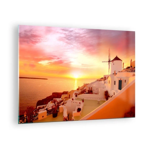 Obraz na skle - Západ slnka nad Santorini s bielymi budovami a veterným mlynom - 70x50cm - Rozplynúť sa v bielej a zlatej - Moderná nástenná dekorácia do obývacej izby a spálne ARTTOR