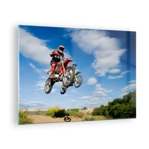 Obraz na skle - Motocyklový pretekár za letu proti modrej oblohe - 70x50cm - Skok z oblakov - Moderná nástenná dekorácia do obývacej izby a spálne ARTTOR