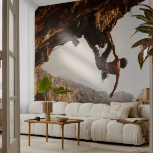 Fototapeta Standard Eco - Horolezectvo na strmom útese s pôsobivým výhľadom - 100x70cm - Svet zovretý v ruke na zosuve balvanu - Moderná nástenná dekorácia do obývacej izby a spálne ARTTOR